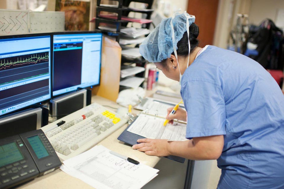 A nurse struggling with paperwork